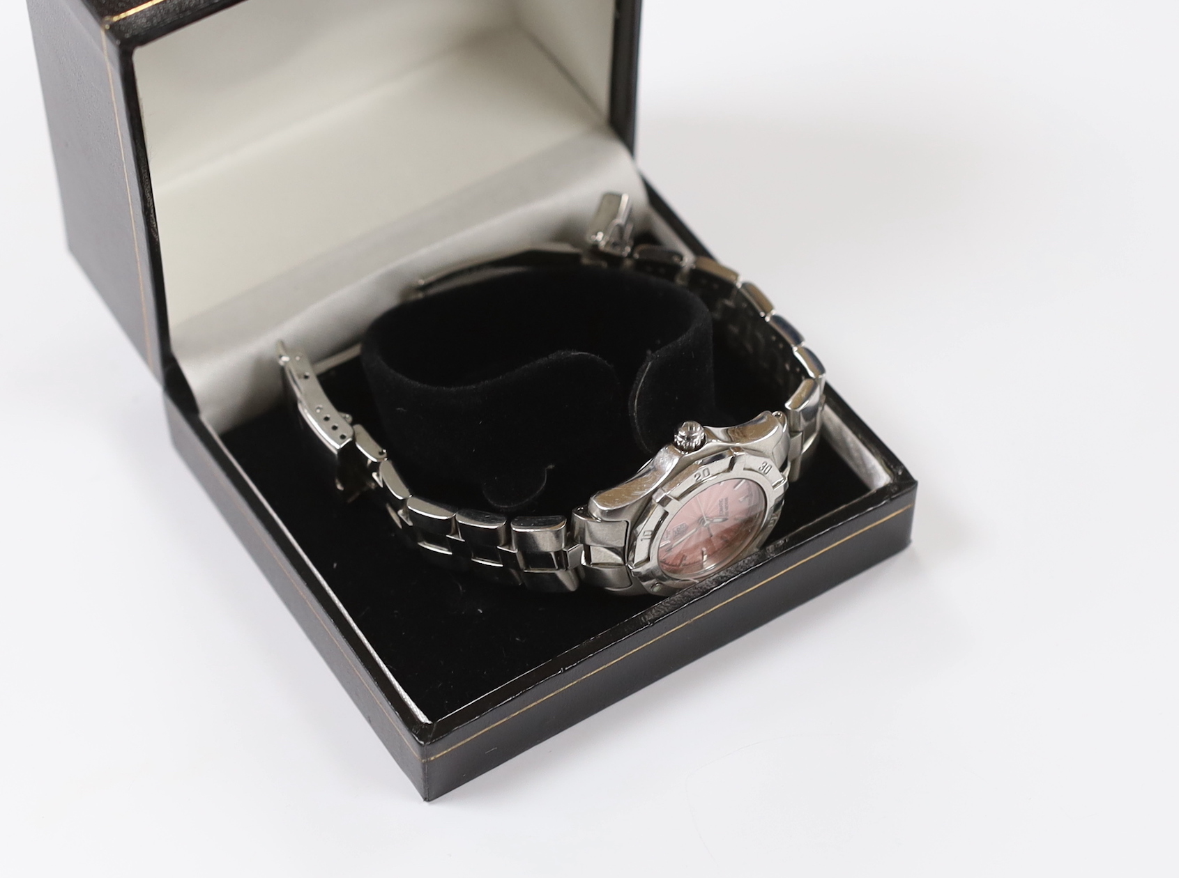 A lady's modern stainless steel Tag Heuer automatic wrist watch, with pink dial, on a Tag Heuer stainless steel bracelet. Condition - fair to poor